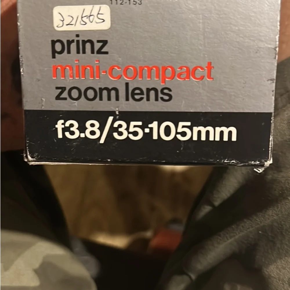 Two lenses one made by canon one made by prinz in box
